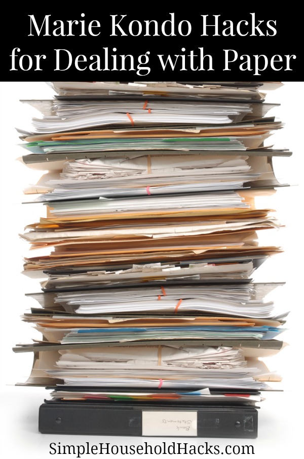 Pile of documents and file folders on white background